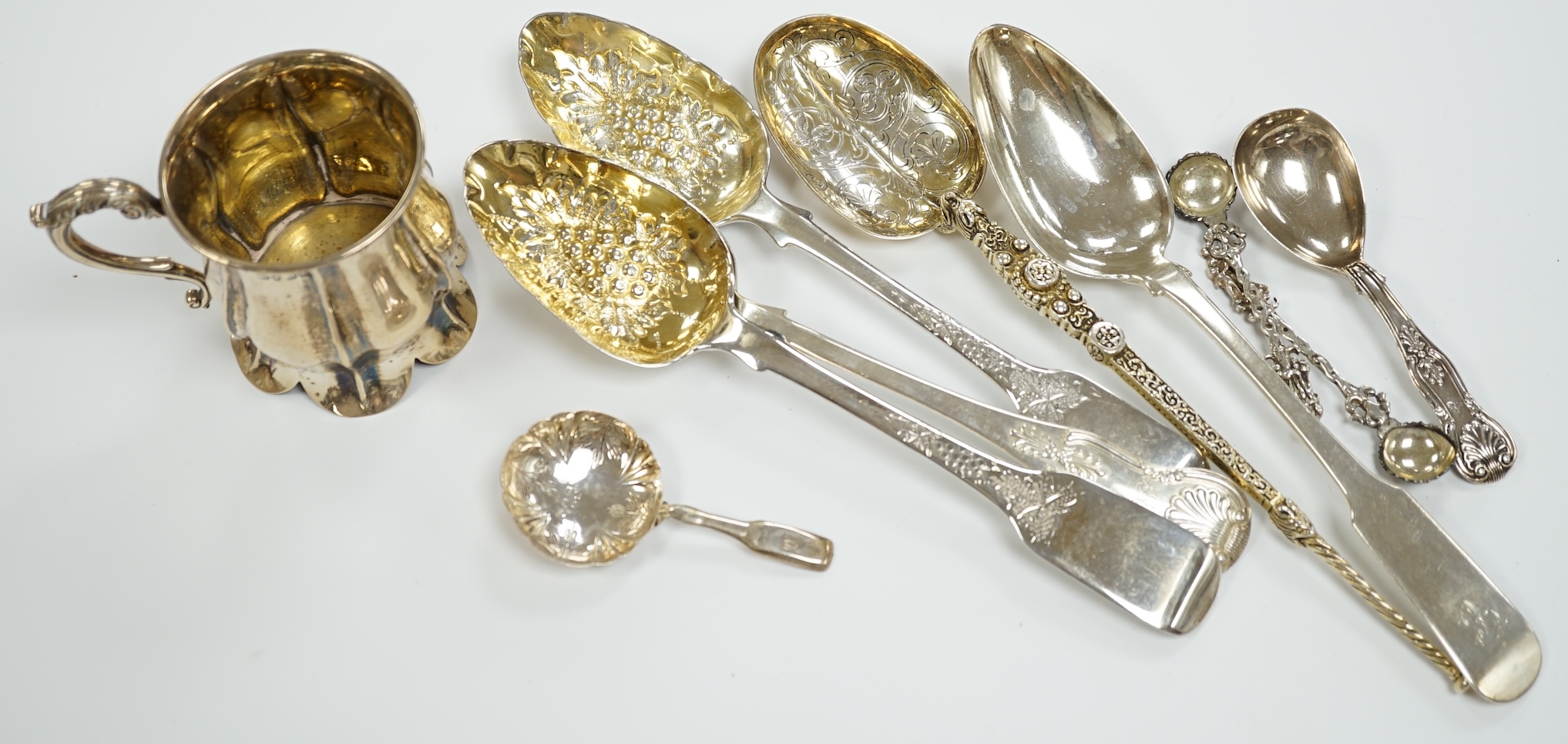 An Edwardian silver 'anointing spoon' Wakeley & Wheeler, London, 1901, 25.5cm, eight other silver spoons including two 19th century caddy spoons and a silver christening mug, 17.7oz.